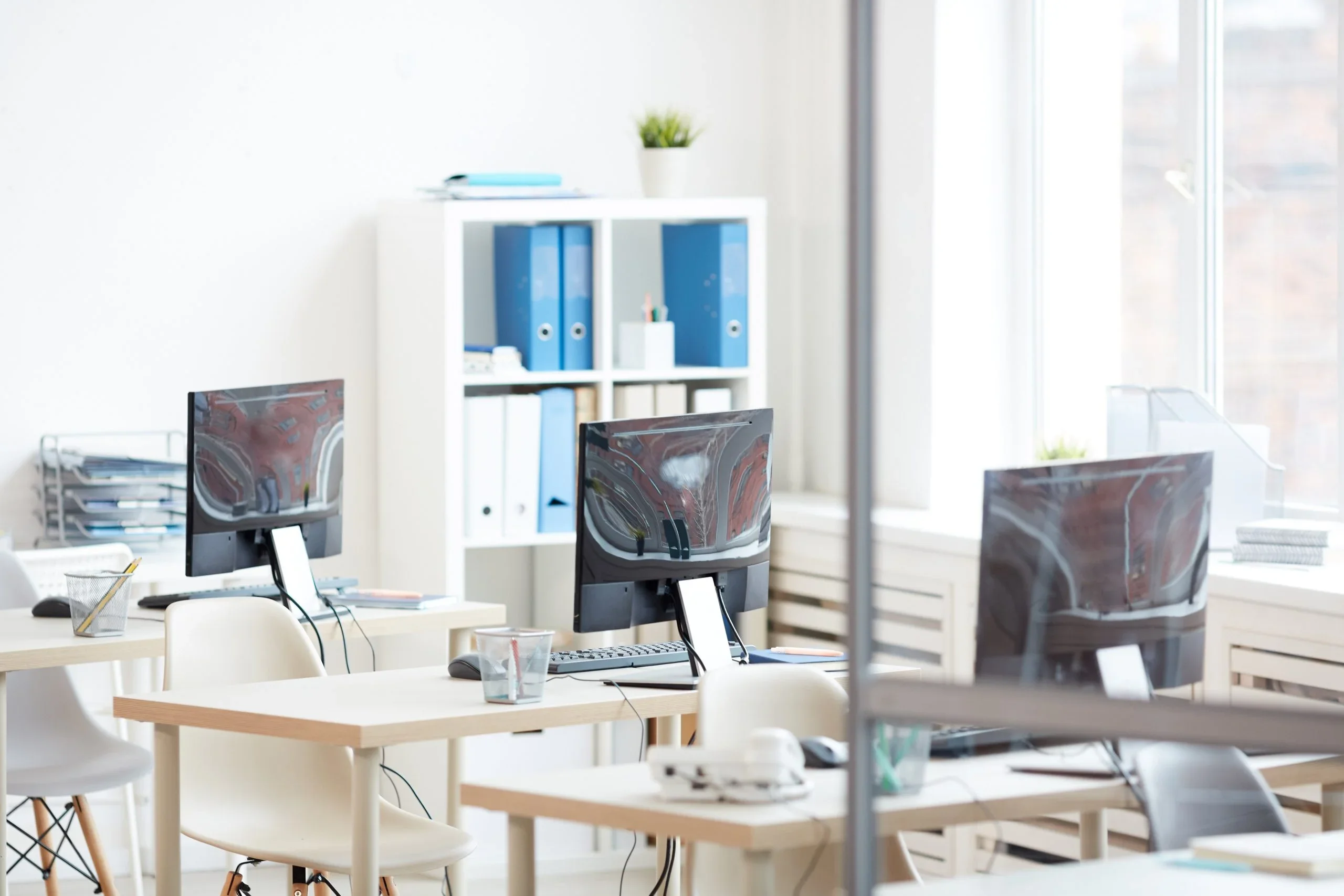 Modern office workspace with computers; ideal for security camera installation.