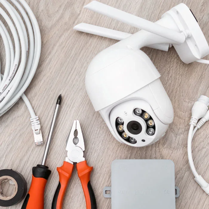 Security camera installation kit: camera, cables, tools.