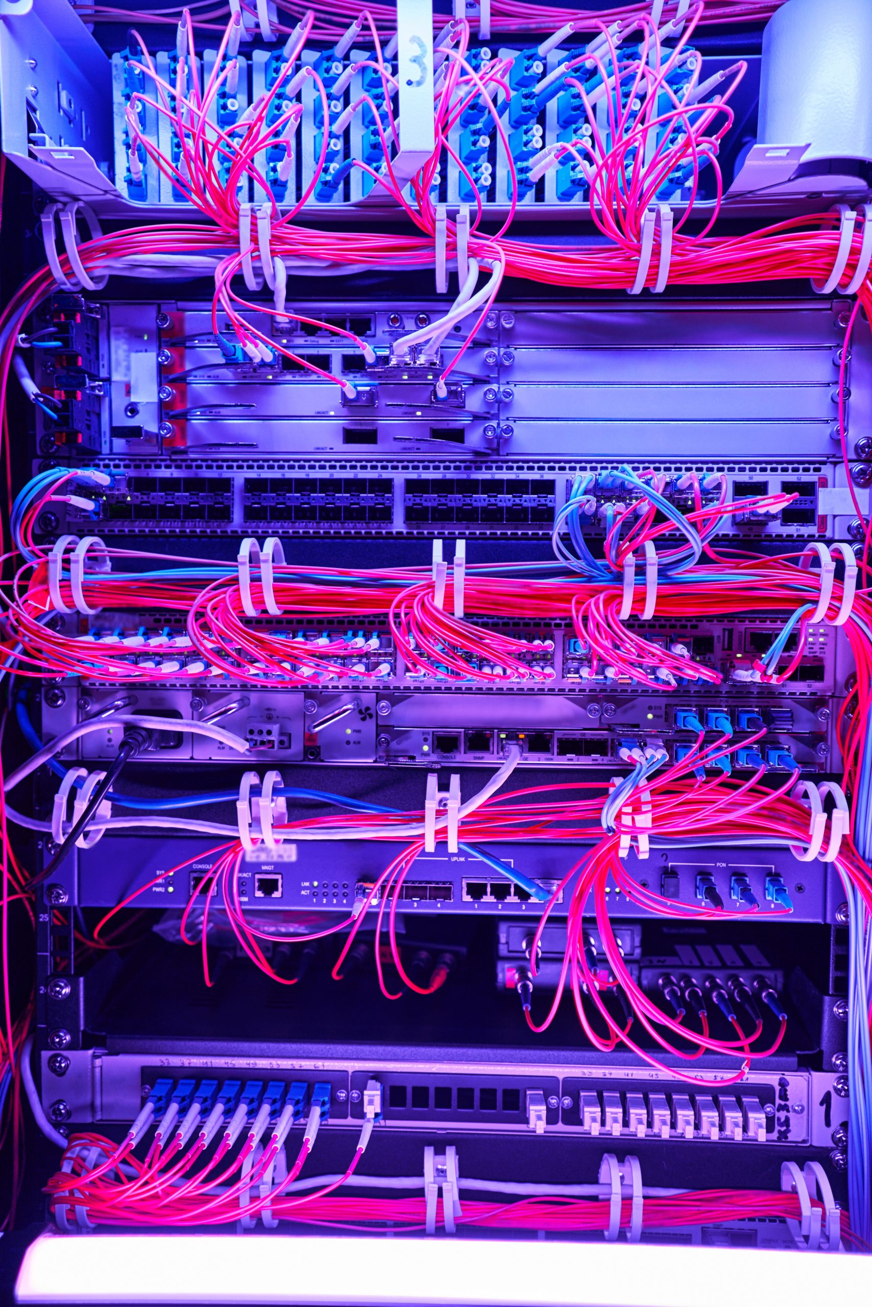 High-density fiber optic network cabling in server rack.